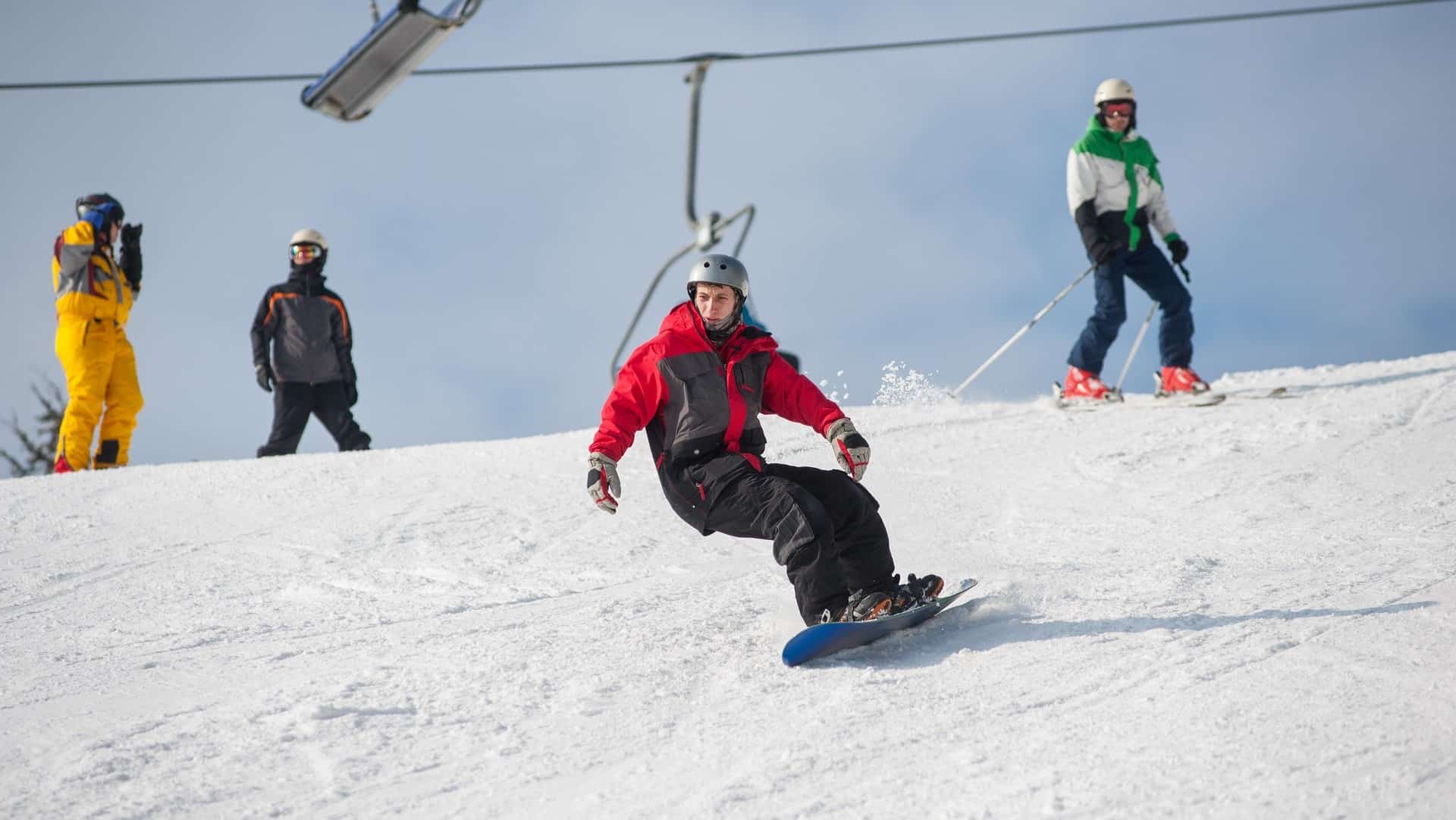 snowboarders riding down from the mountain